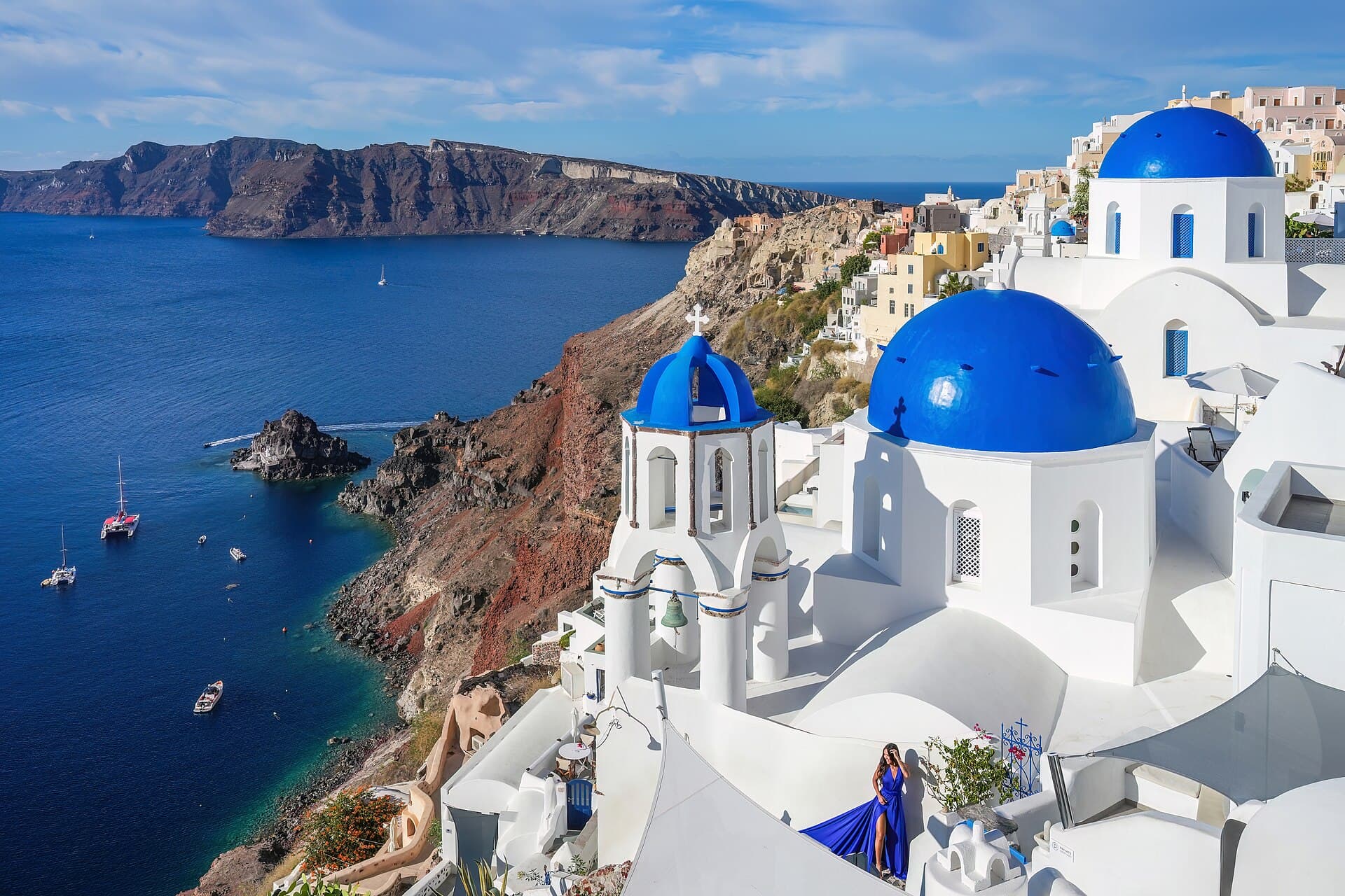 Blue domes and white houses of Oia above the Santorini caldera